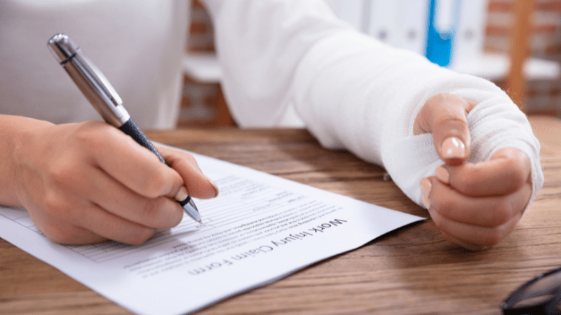 An injured worker fills out a Work Injury Claim form